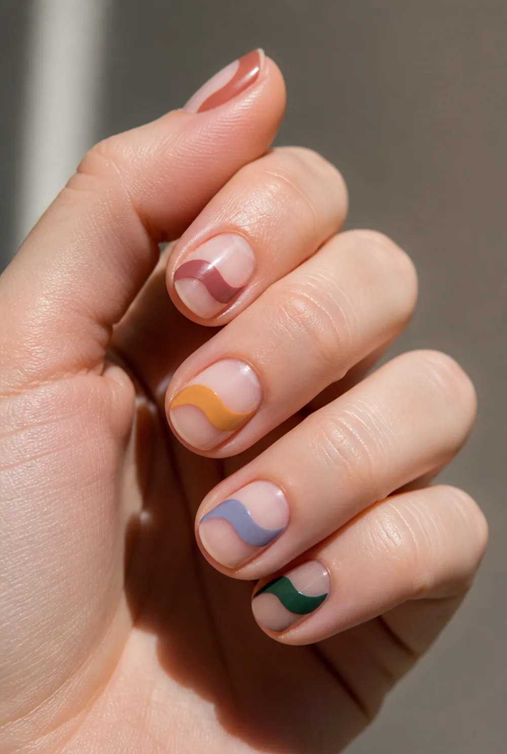 negative space arc nail art on fair skin, short length