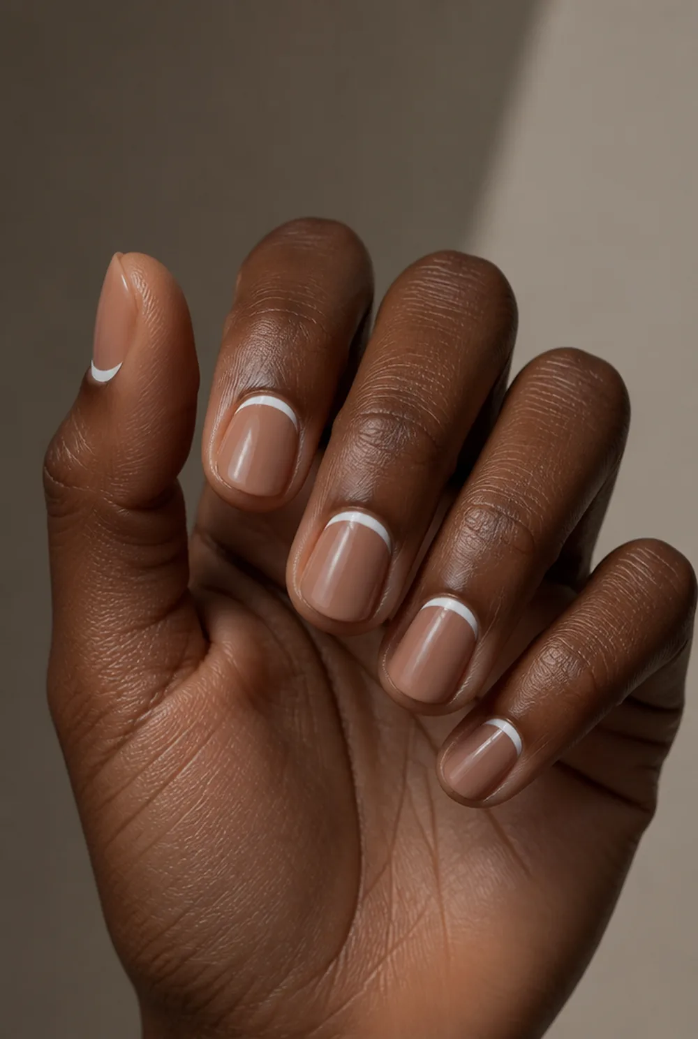 reverse french nail art on deep brown skin