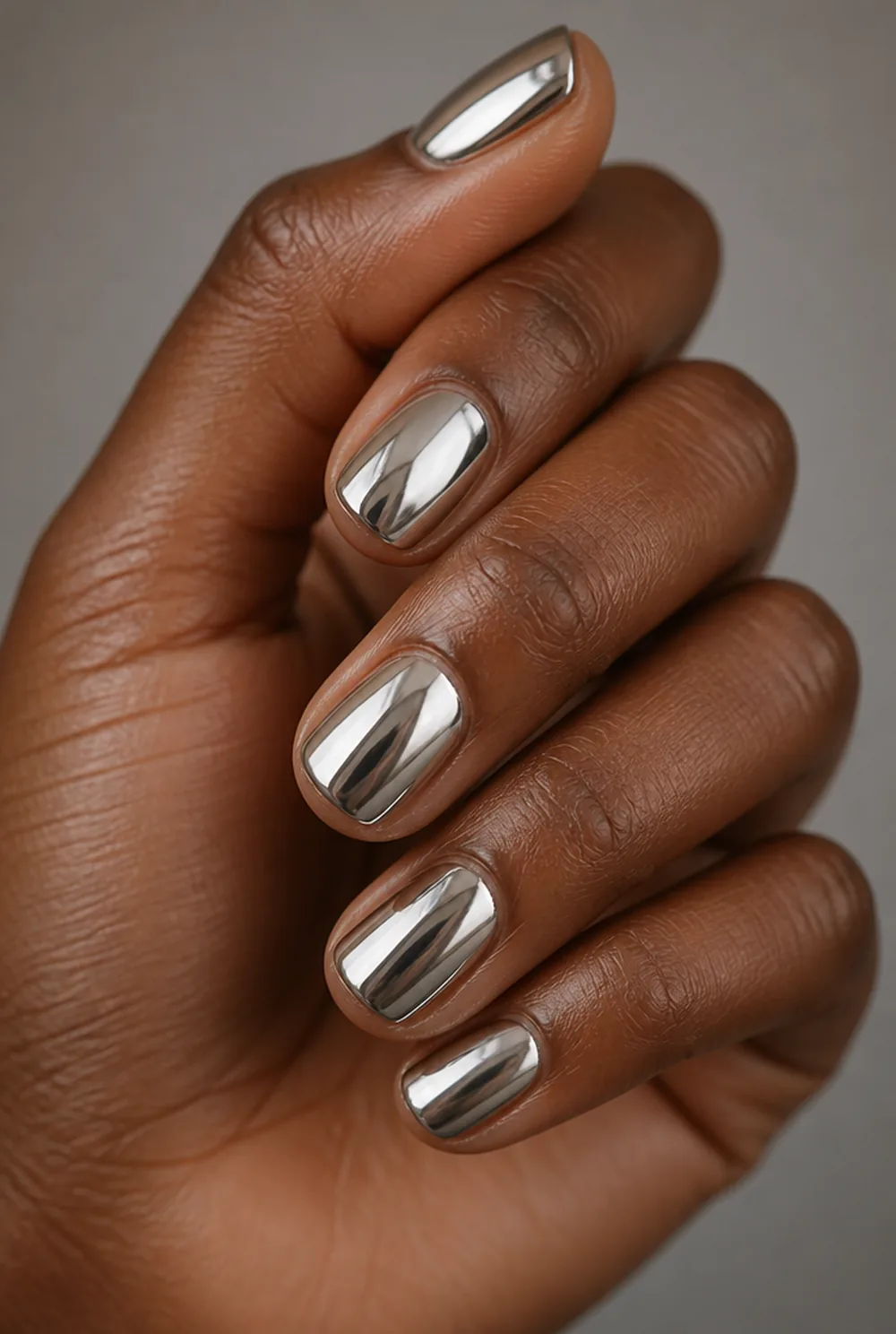 full mirror chrome nail art on deep brown skin