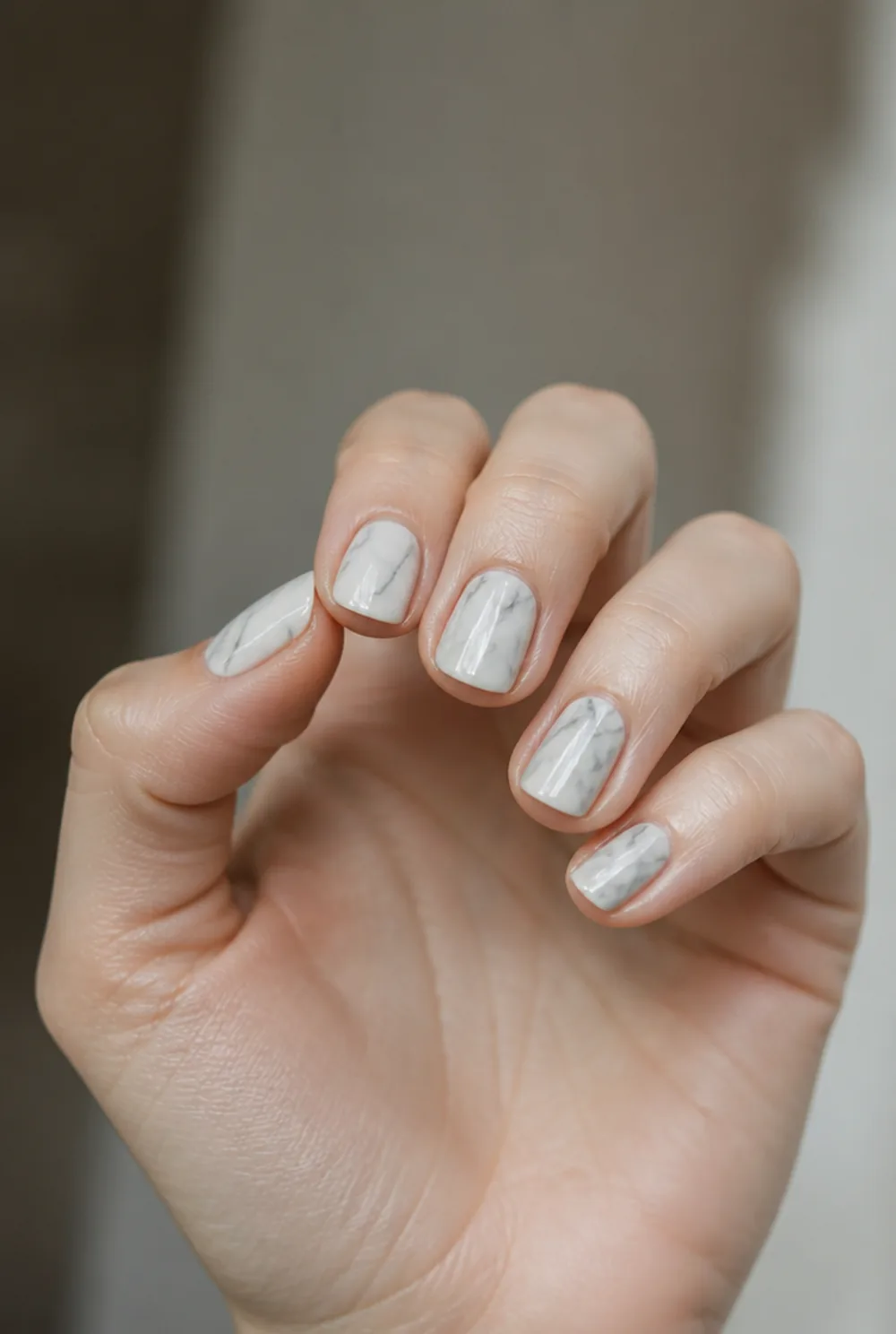 marble nail art on fair skin, short length