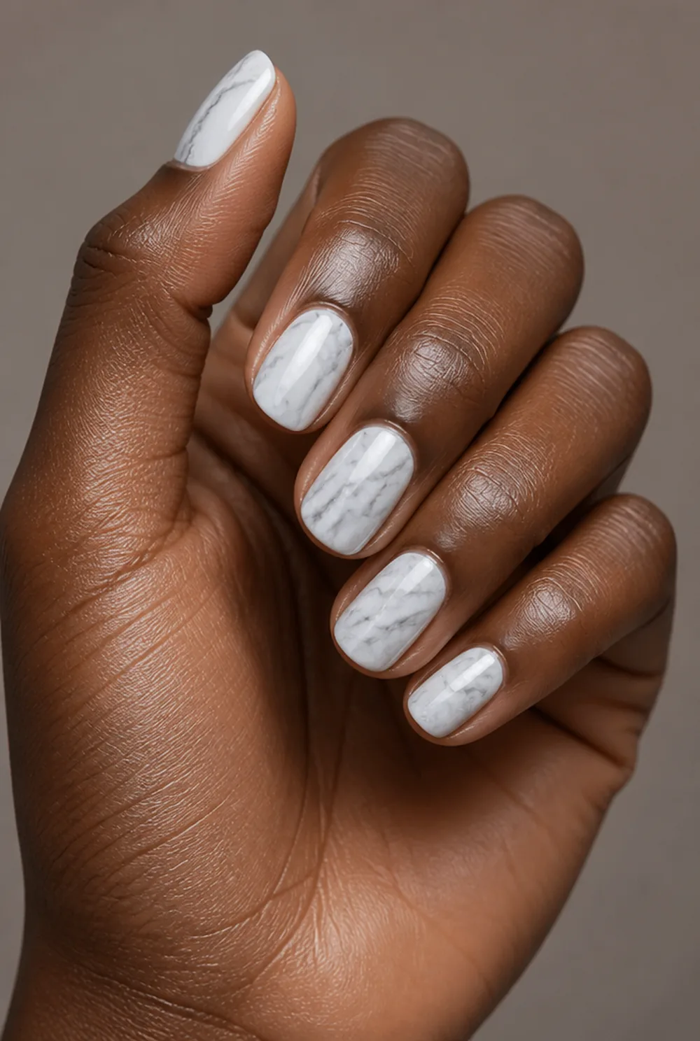 marble nail art on deep brown skin