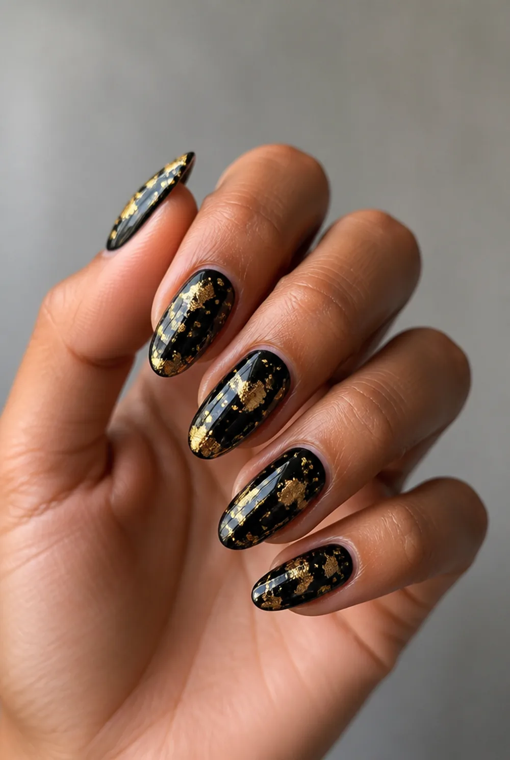 gold foil flakes nail art on olive skin, long length
