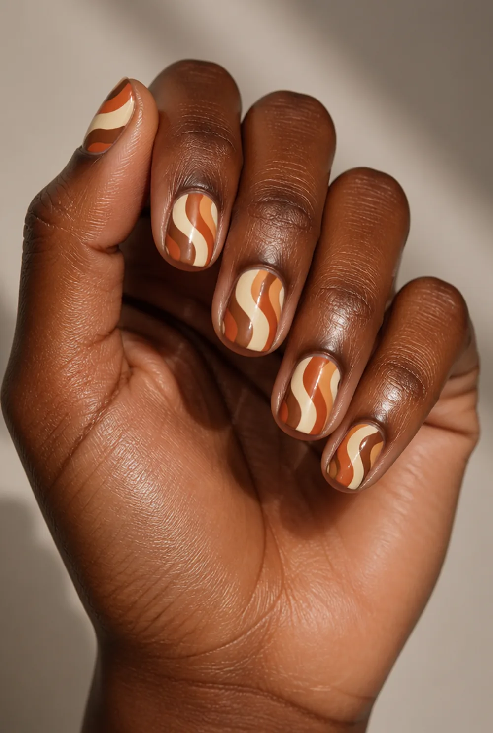 retro swirls nail art on deep brown skin