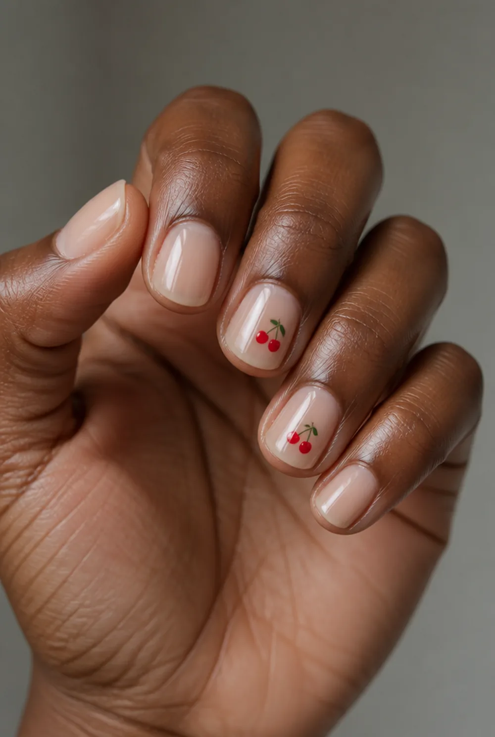 tiny cherries nail art on deep brown skin