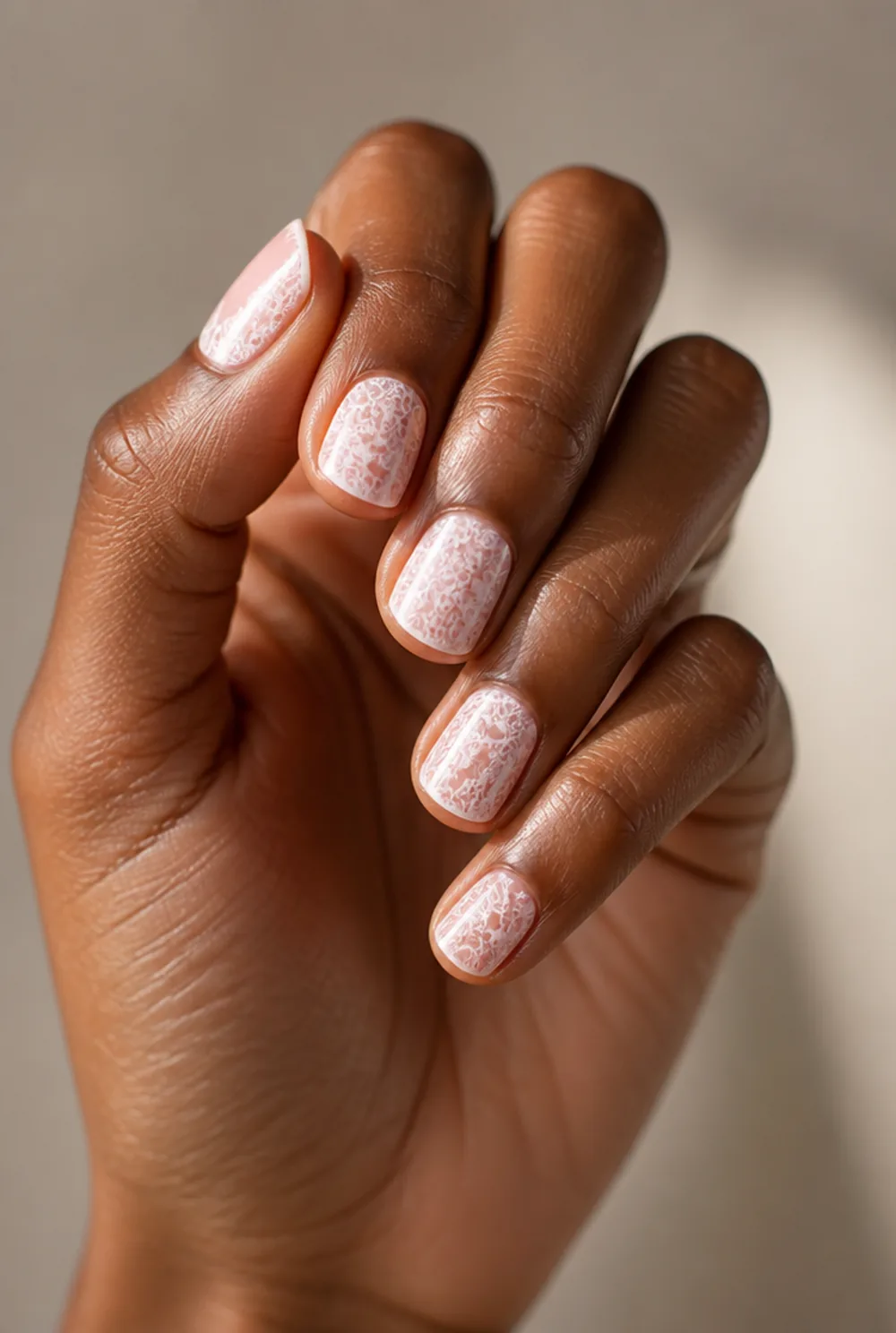 stamped lace nail art on deep brown skin