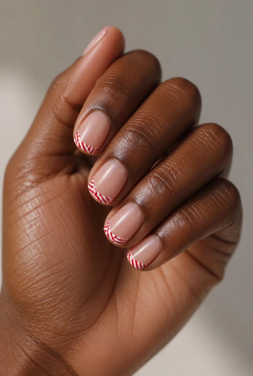 candy cane french nail art on deep brown skin