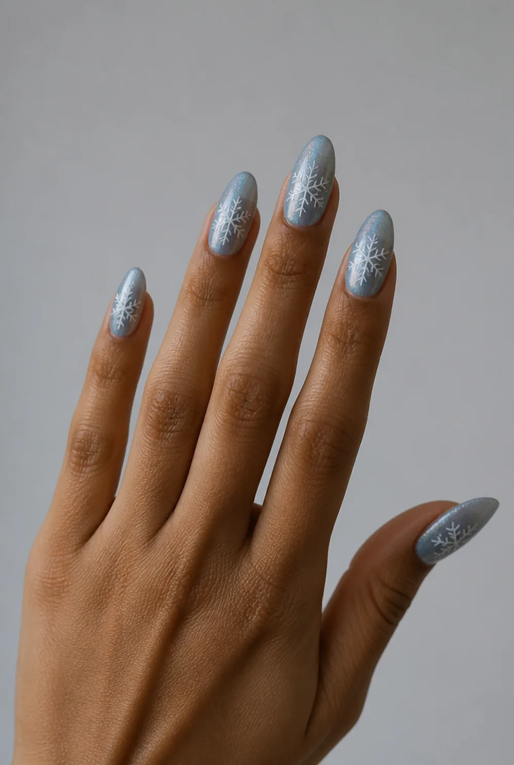 snowflake accent nail art on olive skin, long length