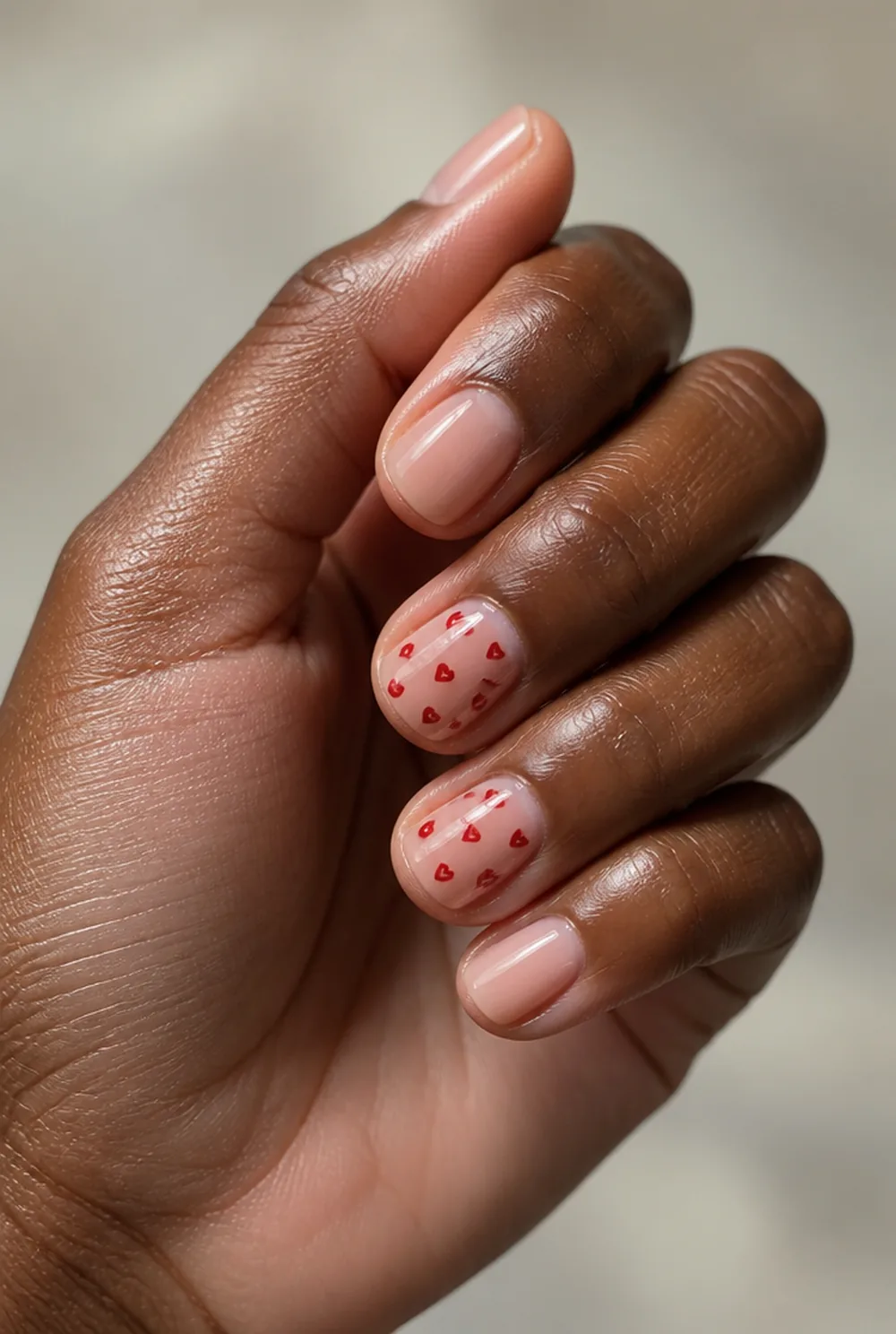 micro hearts nail art on deep brown skin