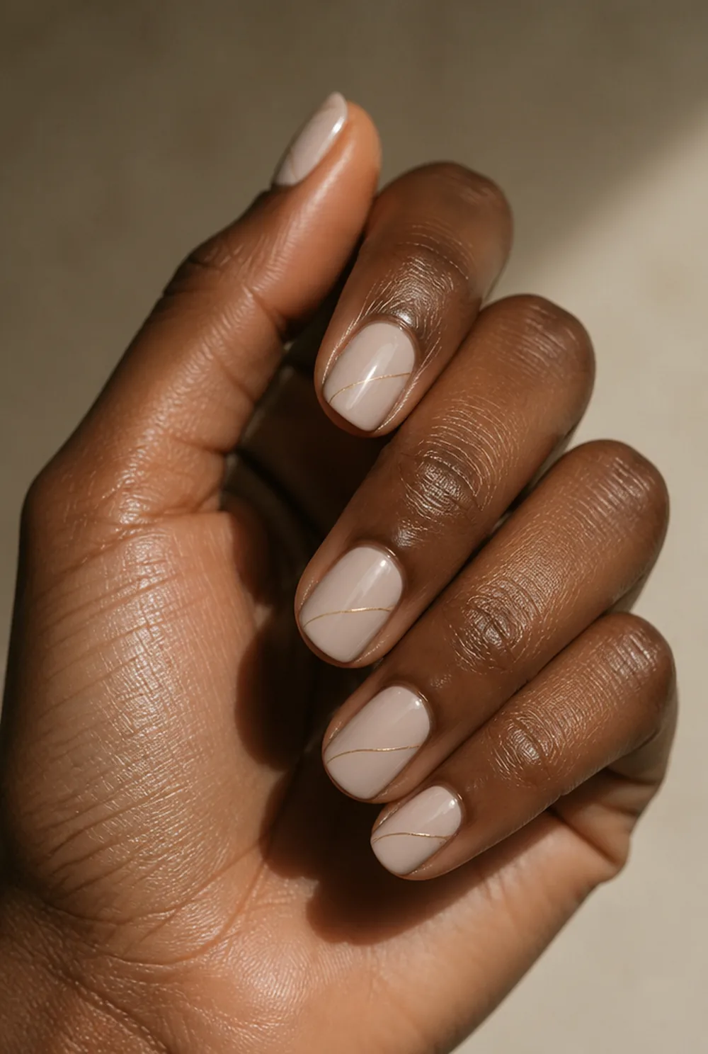 minimal gold line art nail art on deep brown skin - PolishedAndPrettyNails.com minimal gold line art nail art on deep brown skin