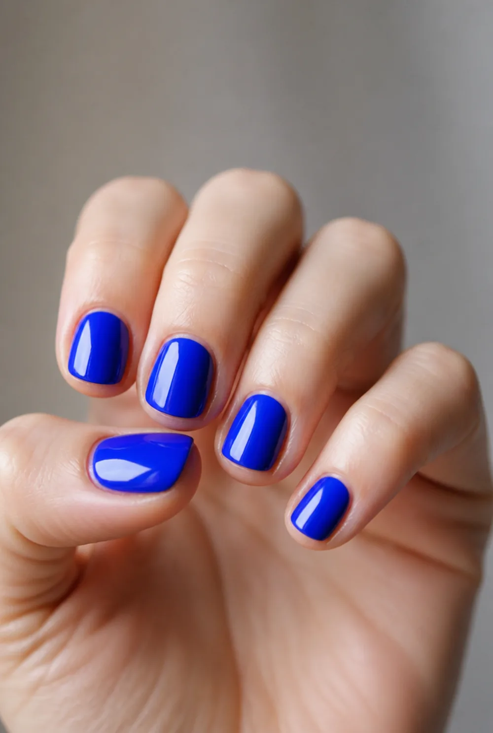 cobalt pop nail art on fair skin, short length