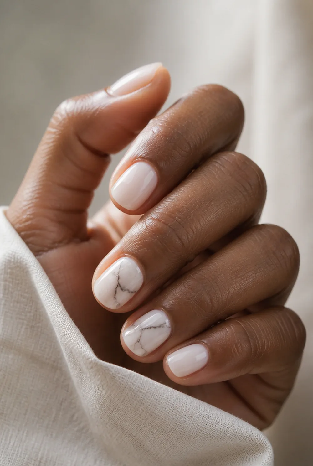 marble accent nail art on deep brown skin