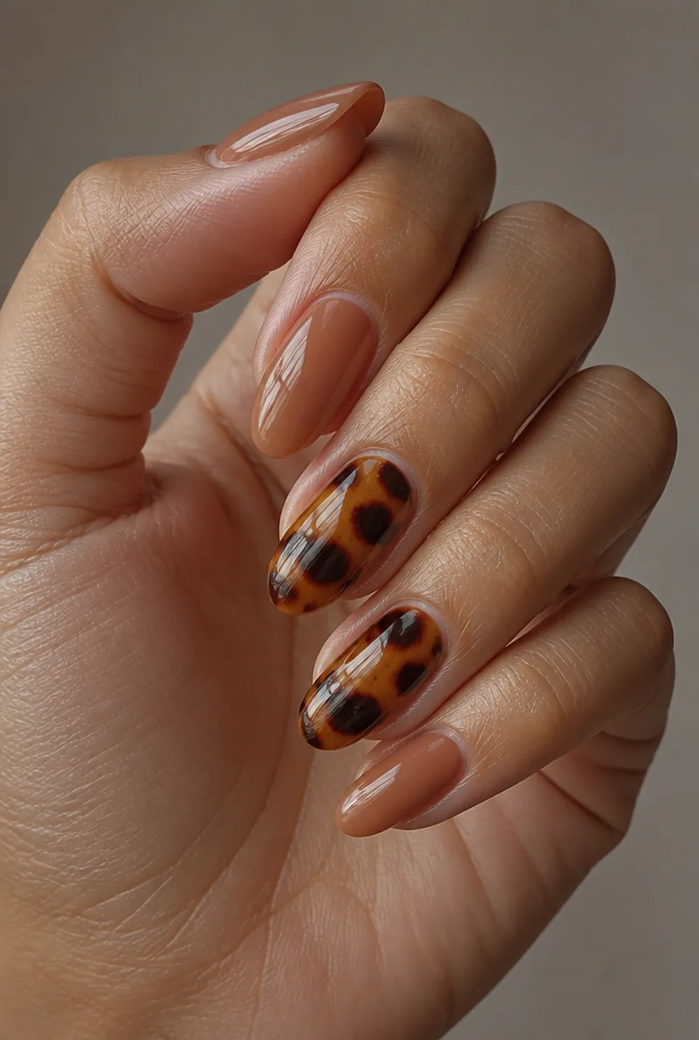 tortoise accent nail art on olive skin, long length