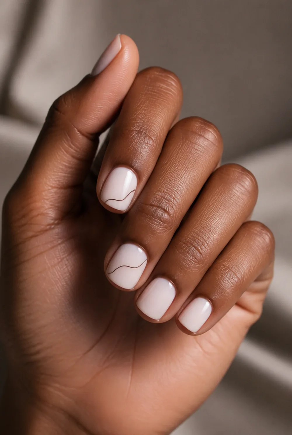 freehand squiggle nail art on deep brown skin