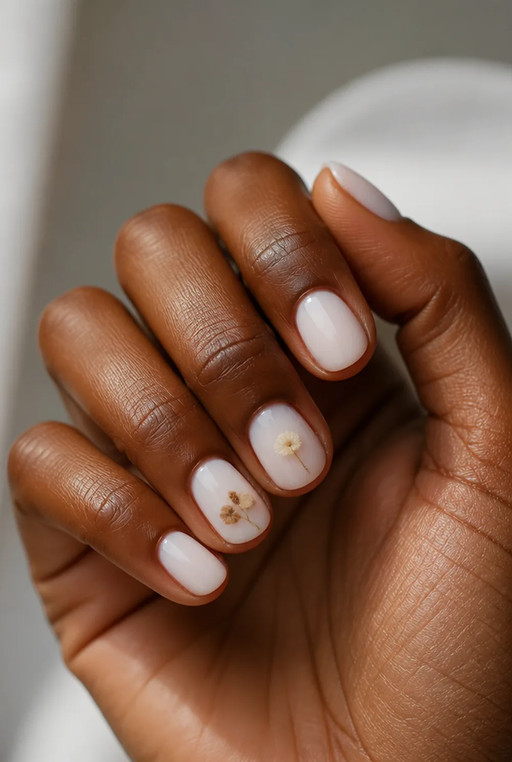 dried flower decal nail art on deep brown skin