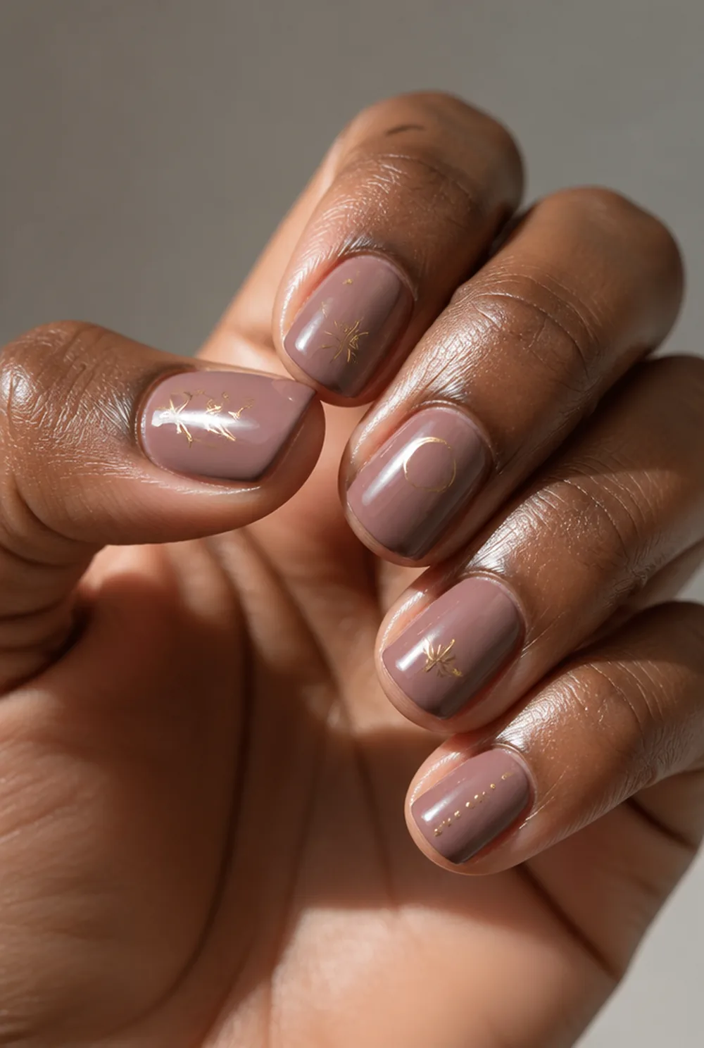 sticker-based art nail art on deep brown skin