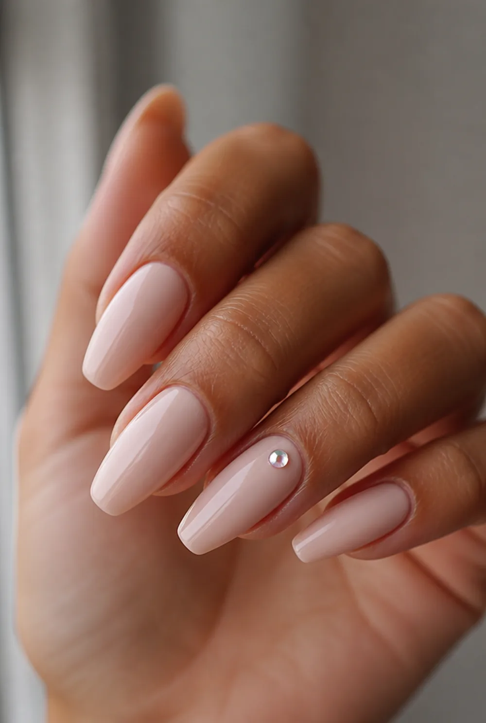 single rhinestone nail art on olive skin, long length