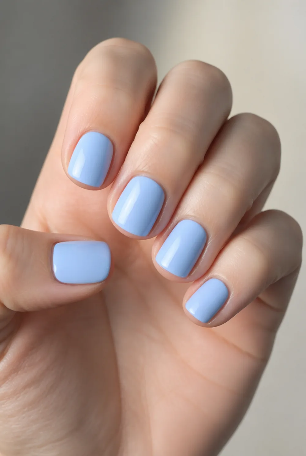 baby blue cream nail art on fair skin, short length