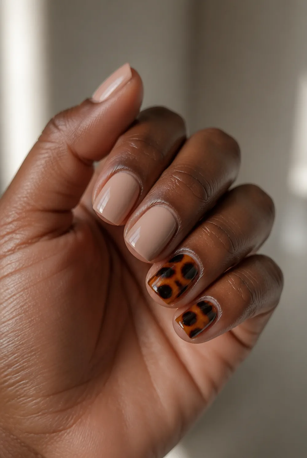 tortoiseshell accent nail art on deep brown skin