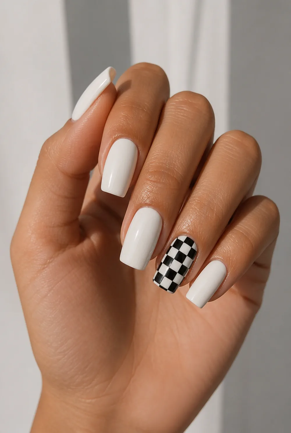 checkerboard accent nail art on olive skin, long length