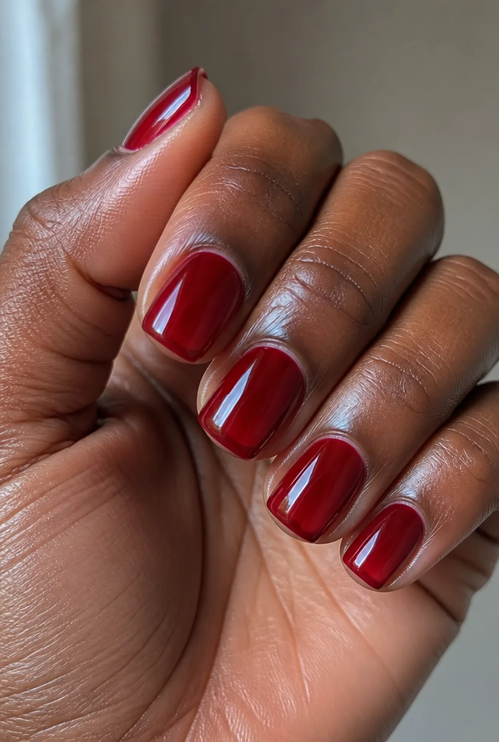 red jelly nail art on deep brown skin