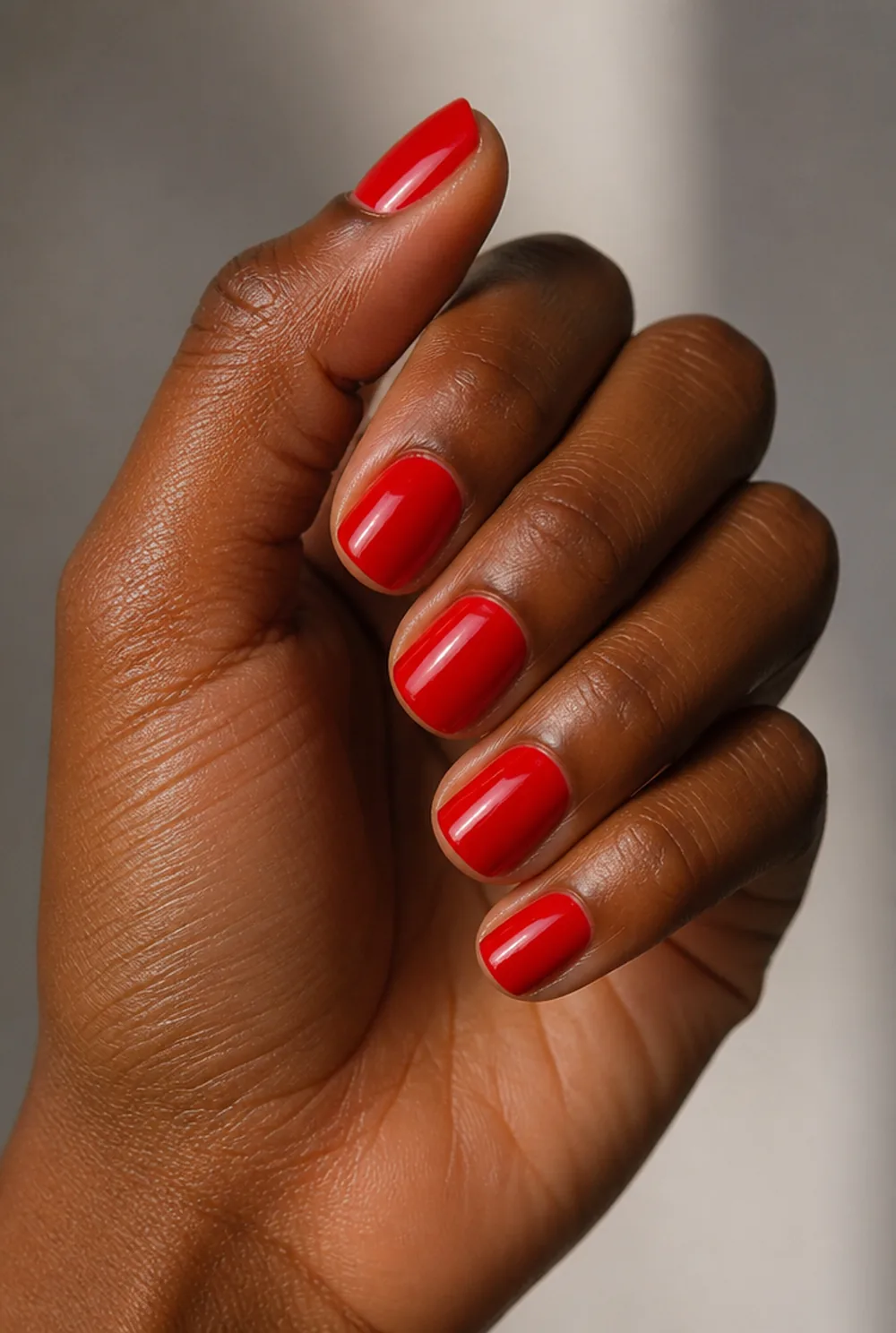 classic red square nail art on deep brown skin