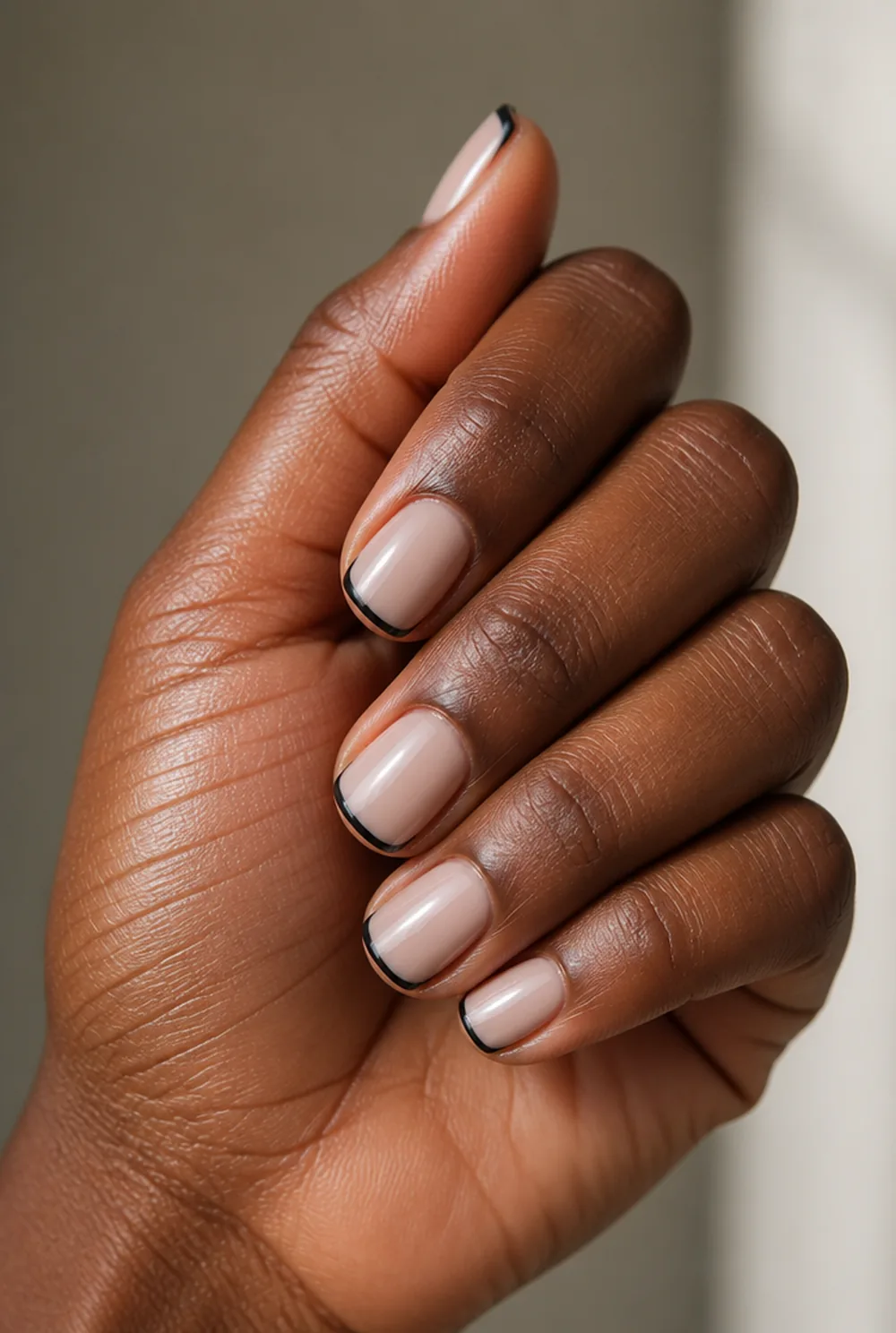 micro french in black nail art on deep brown skin