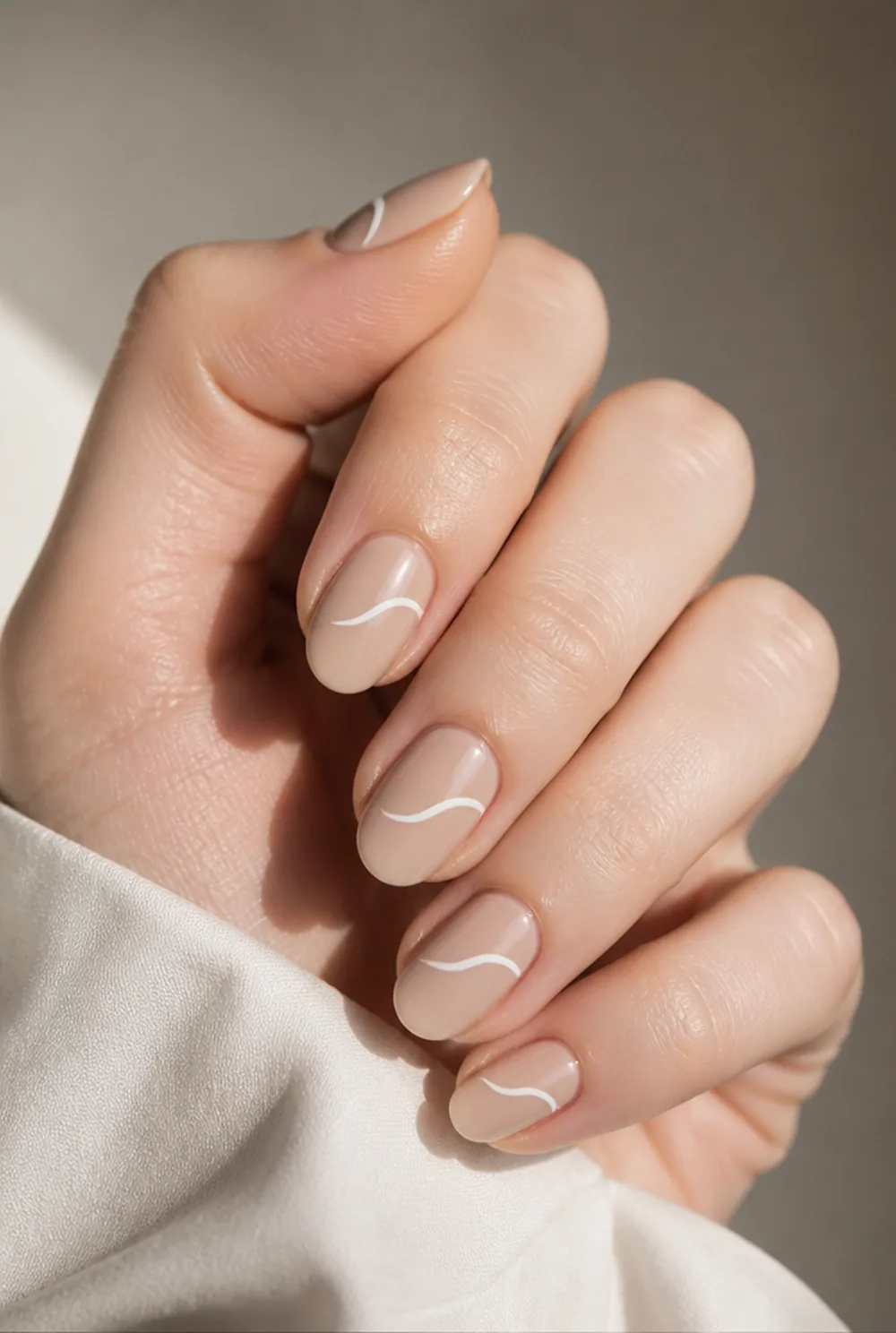 almond swirl nail art on fair skin, short length
