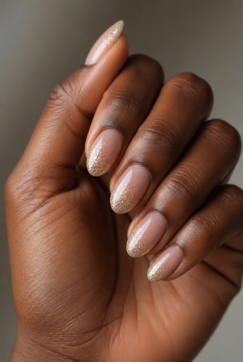 almond glitter tip nail art on deep brown skin