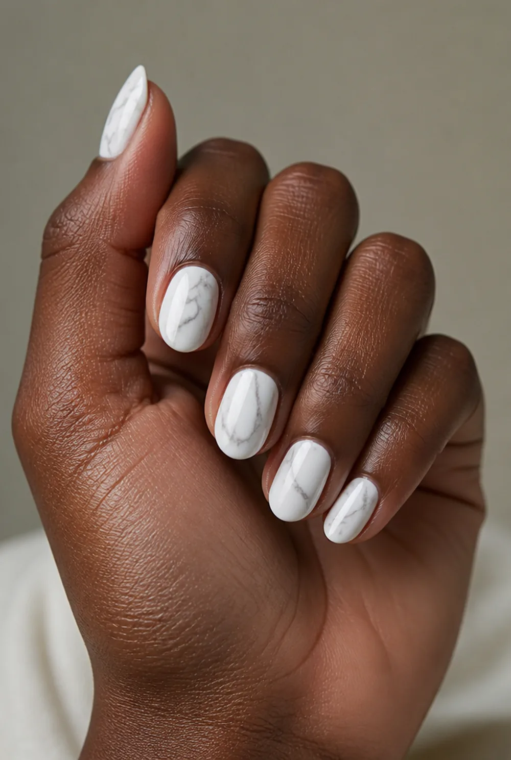 almond marble nail art on deep brown skin