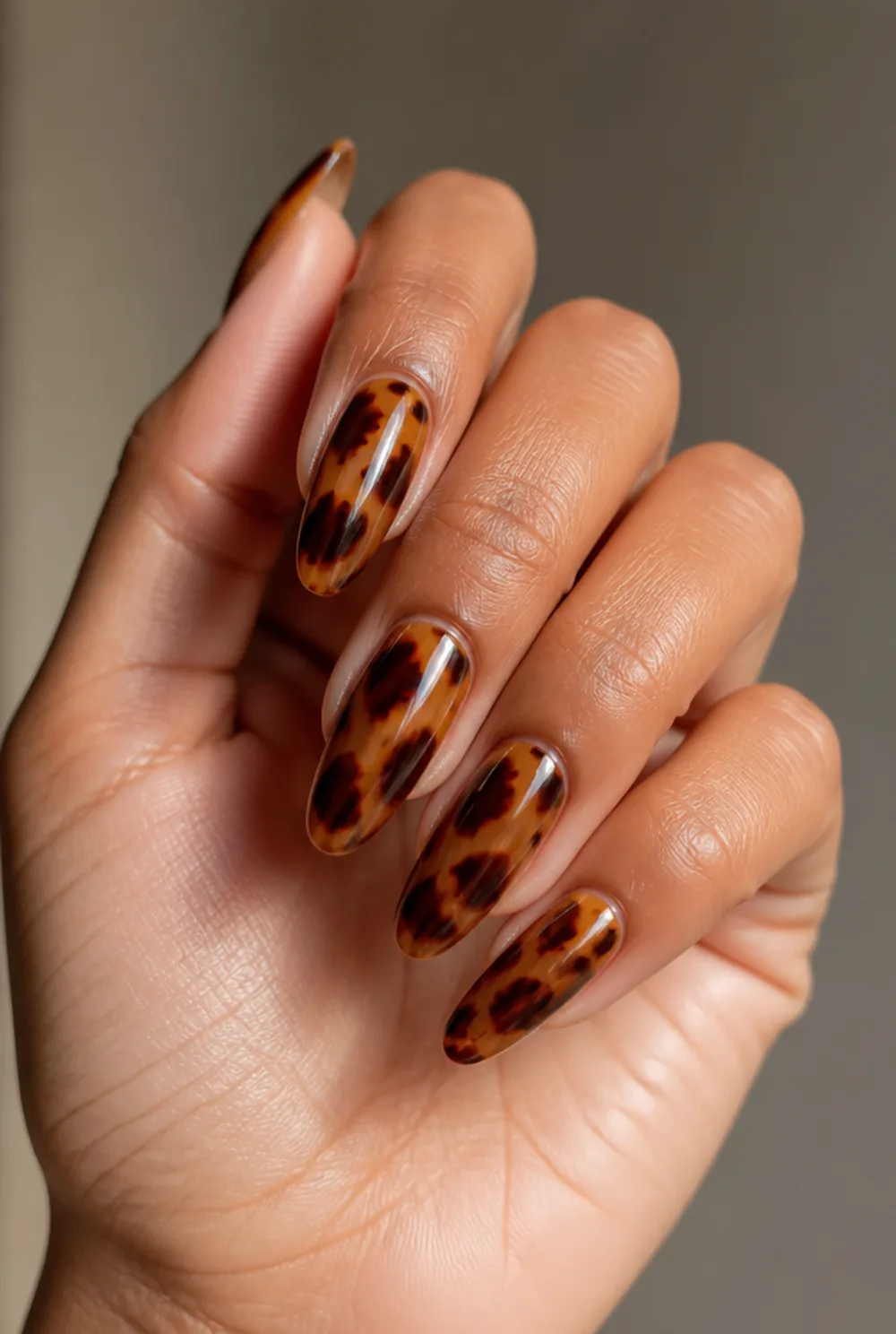 almond tortoiseshell nail art on olive skin, long length