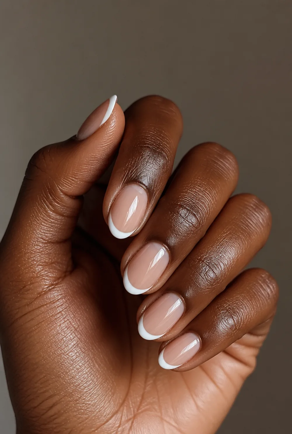 almond french tip nail art on deep brown skin