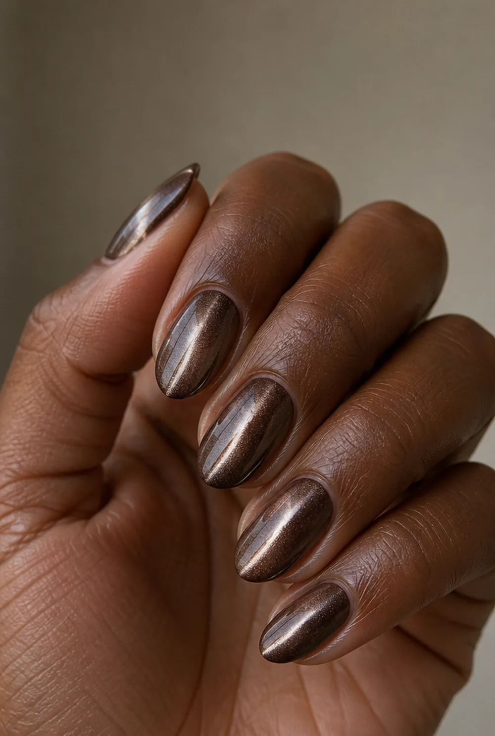 almond cat eye nail art on deep brown skin