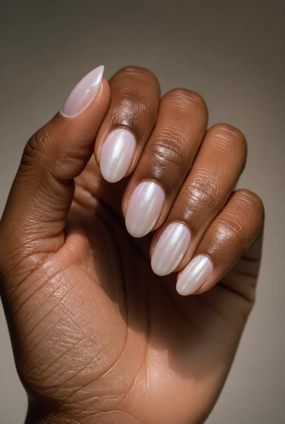 almond glazed pearl nail art on deep brown skin