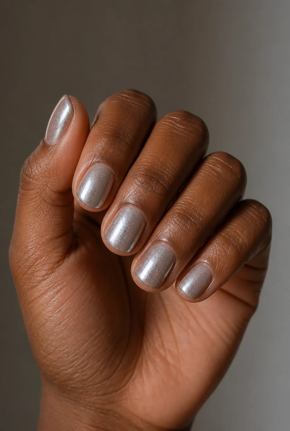 silver aura nail art on deep brown skin