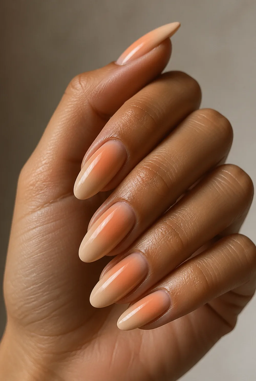 peach aura nail art on olive skin, long length