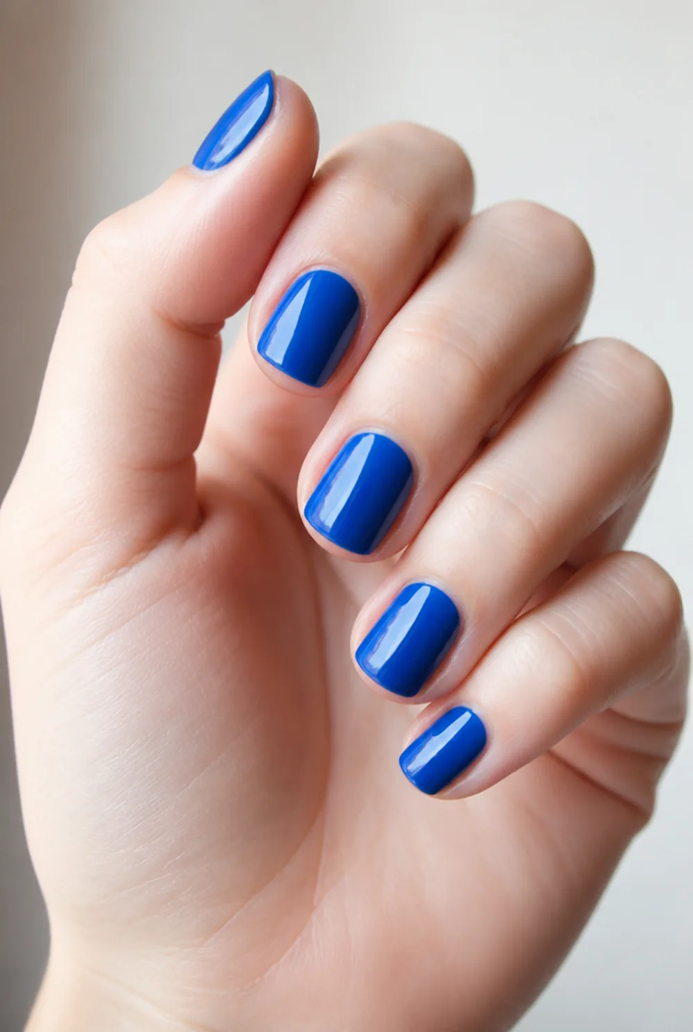 cobalt blue nail art on fair skin, short length