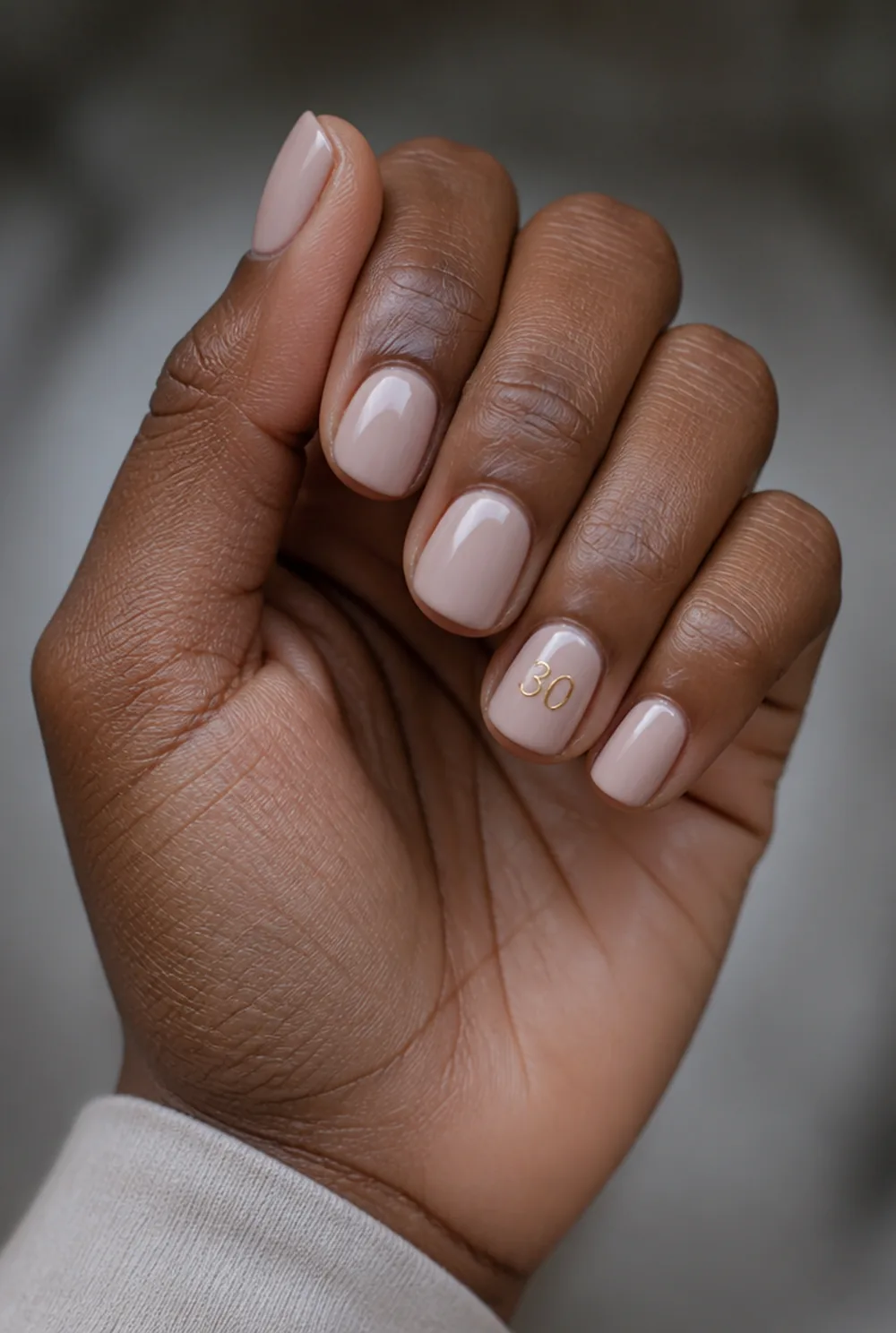 number accent nail art on deep brown skin