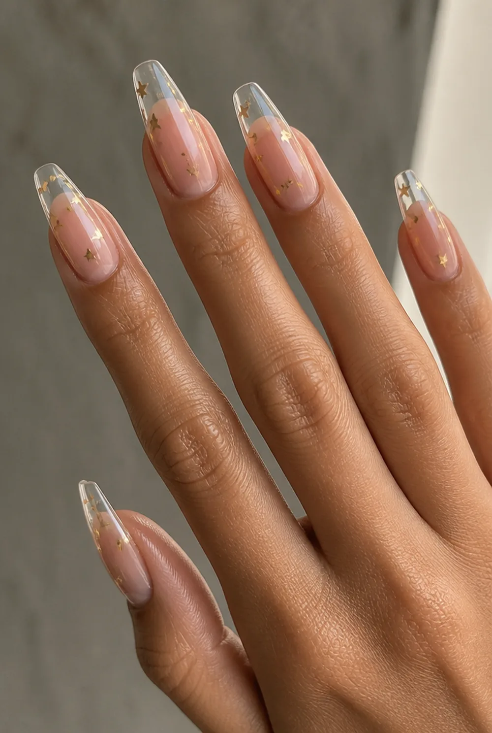 star confetti nail art on olive skin, long length