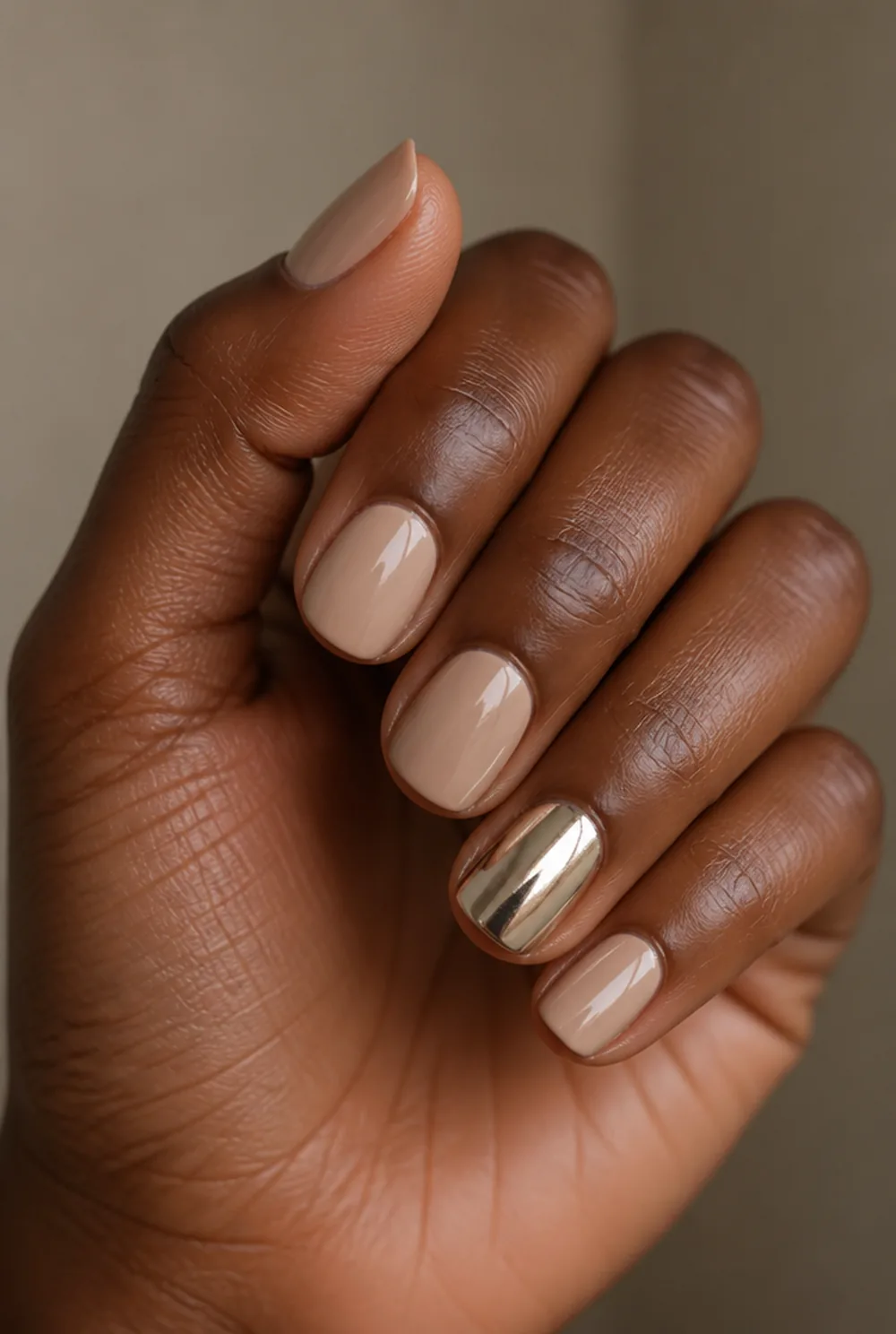 one chrome accent nail art on deep brown skin