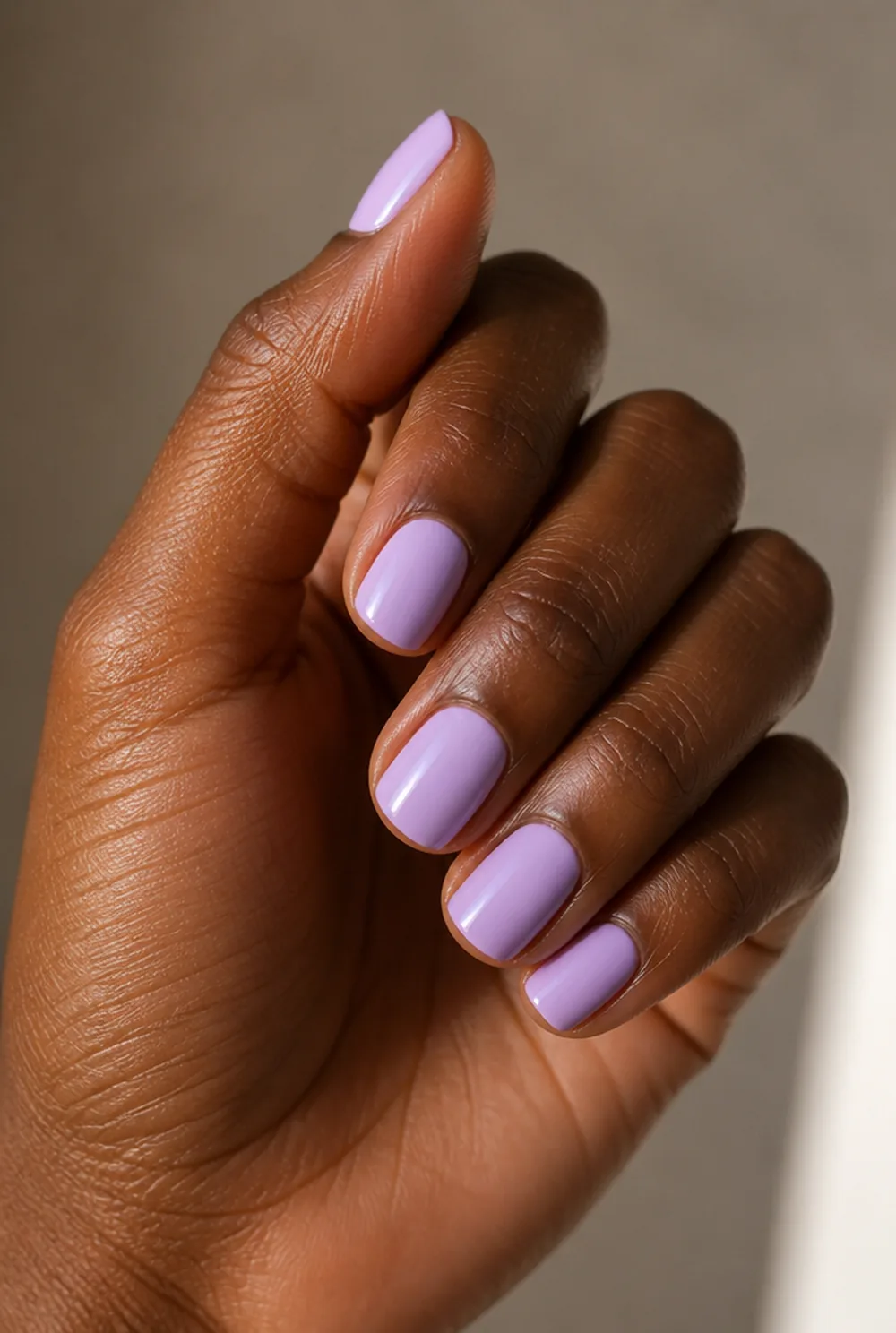 lilac nail art on deep brown skin