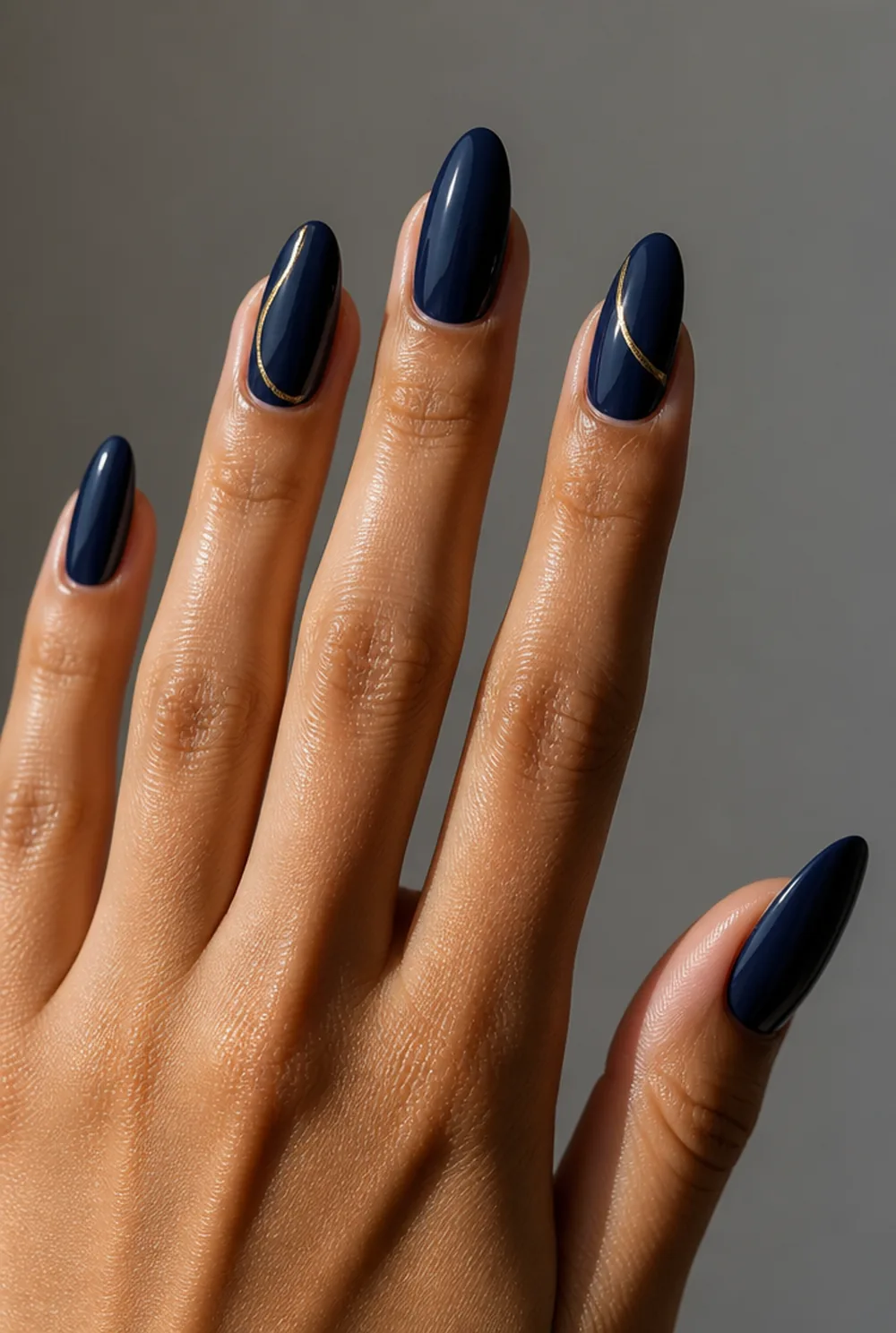 navy and gold nail art on olive skin, long length