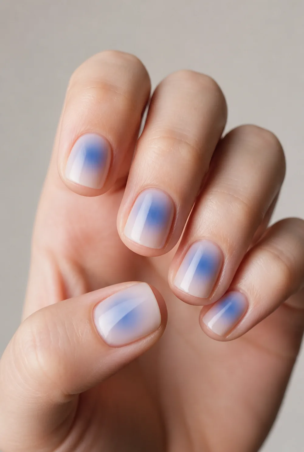 blue aura nail art on fair skin, short length