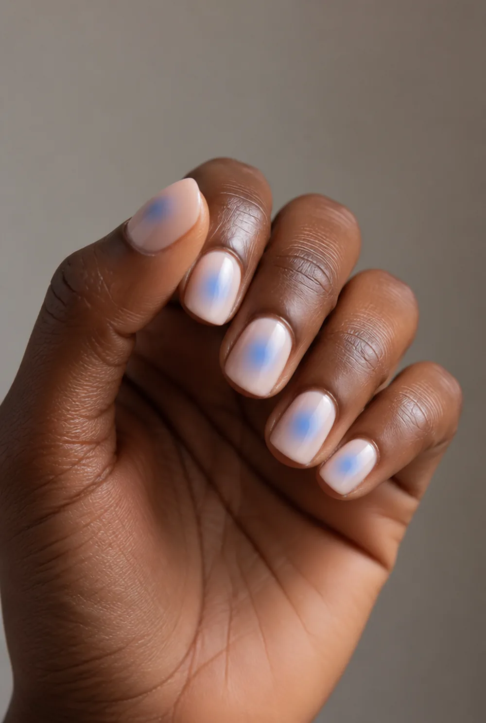 blue aura nail art on deep brown skin