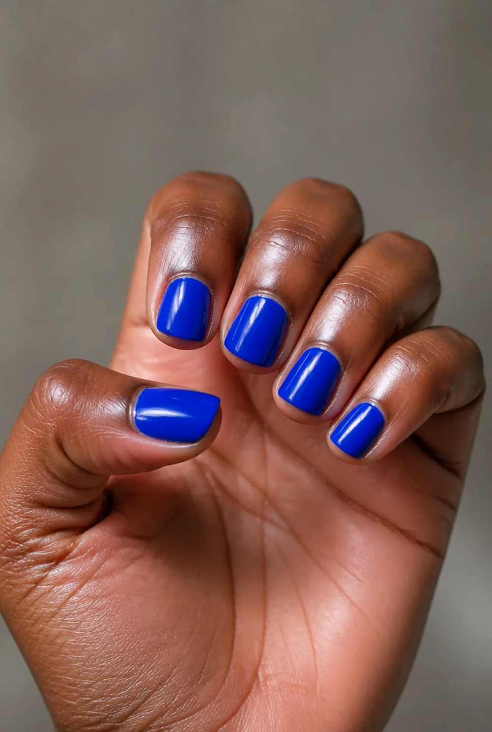 cobalt gloss nail art on deep brown skin