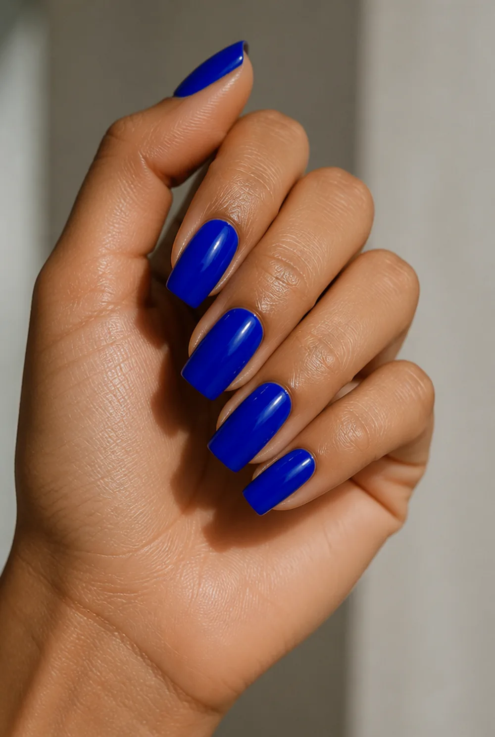 cobalt gloss nail art on olive skin, long length