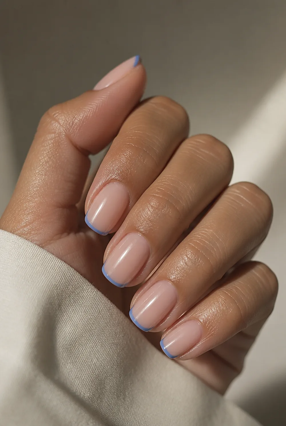 blue micro french nail art on olive skin, long length