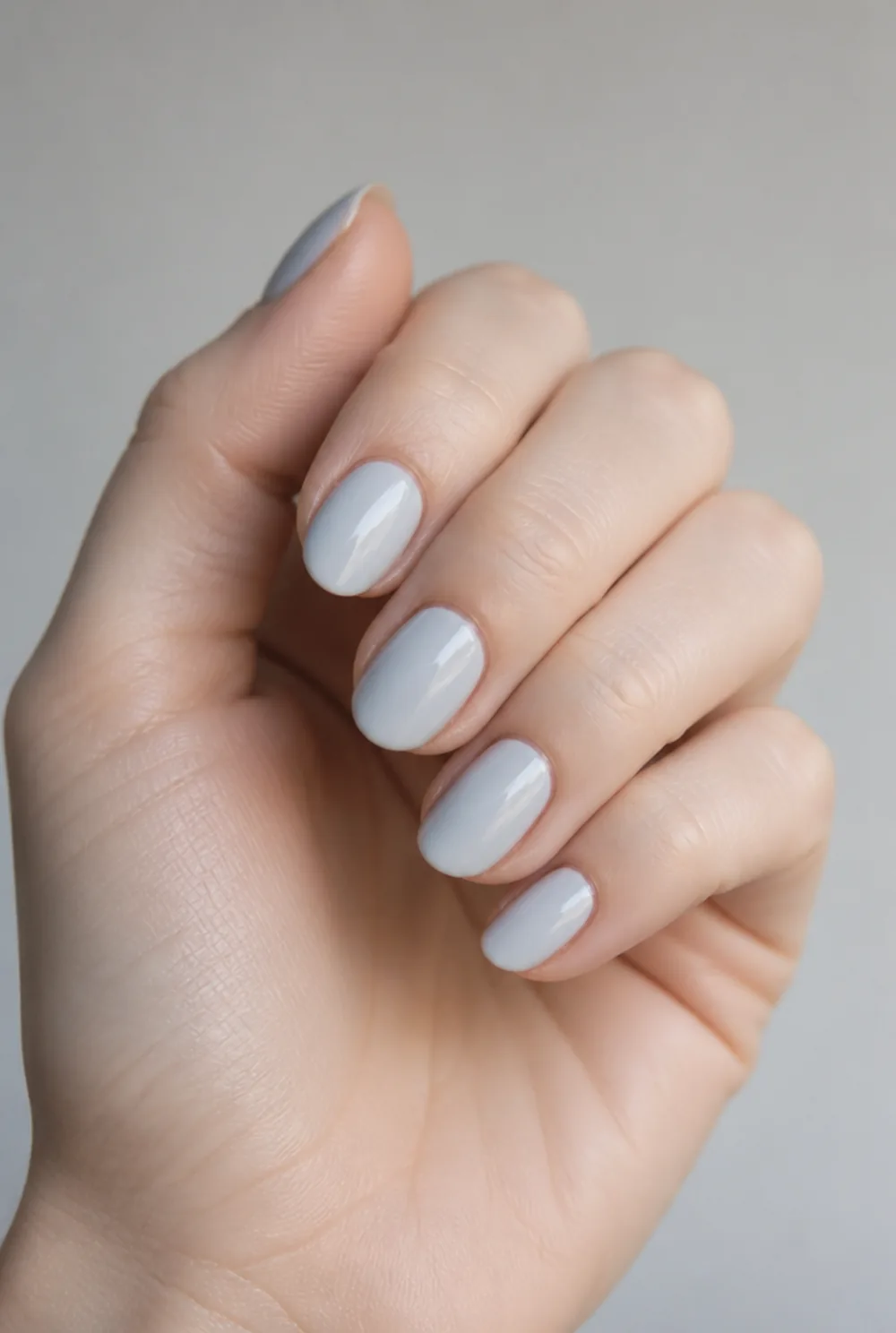 powder blue cream nail art on fair skin, short length
