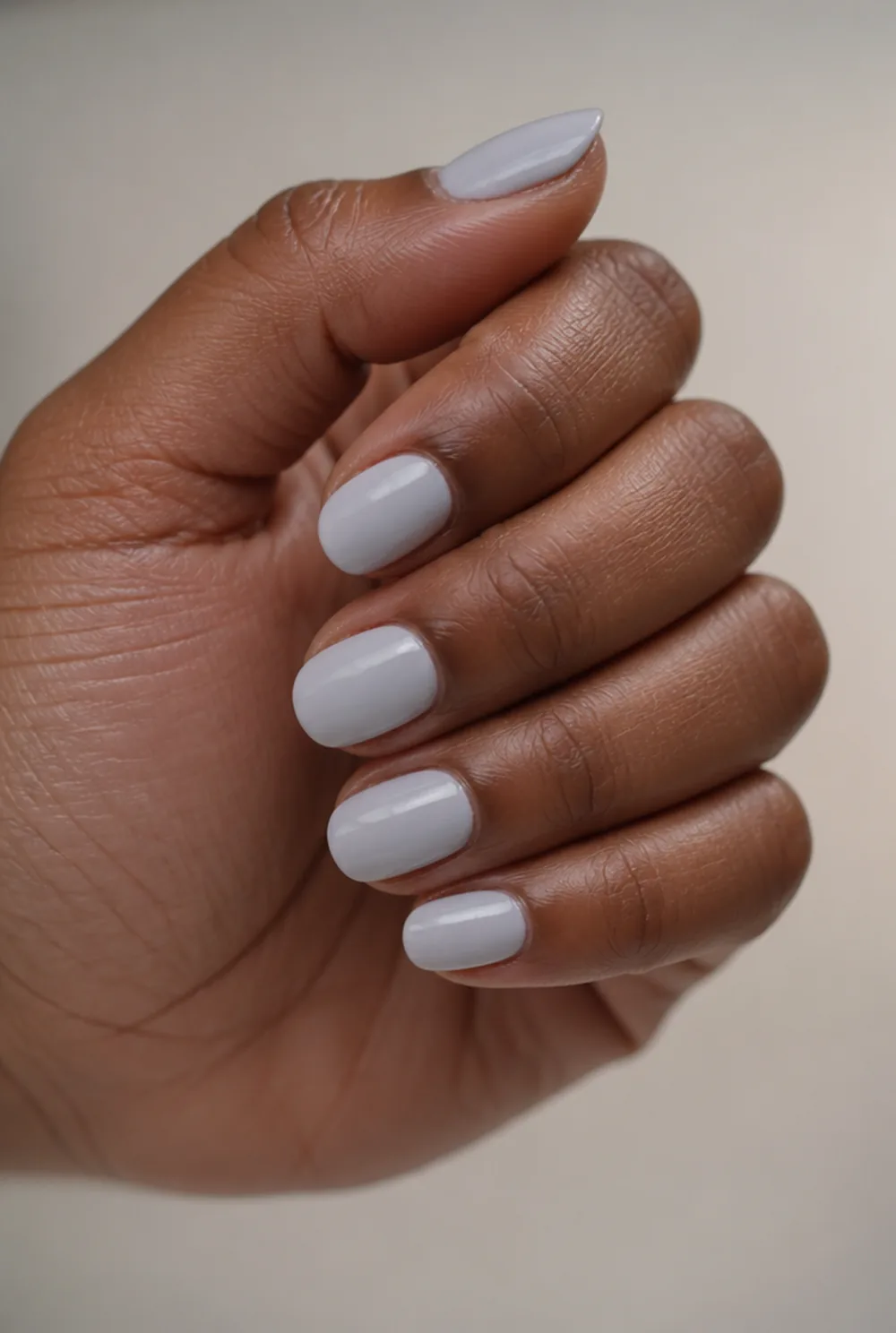 powder blue cream nail art on deep brown skin