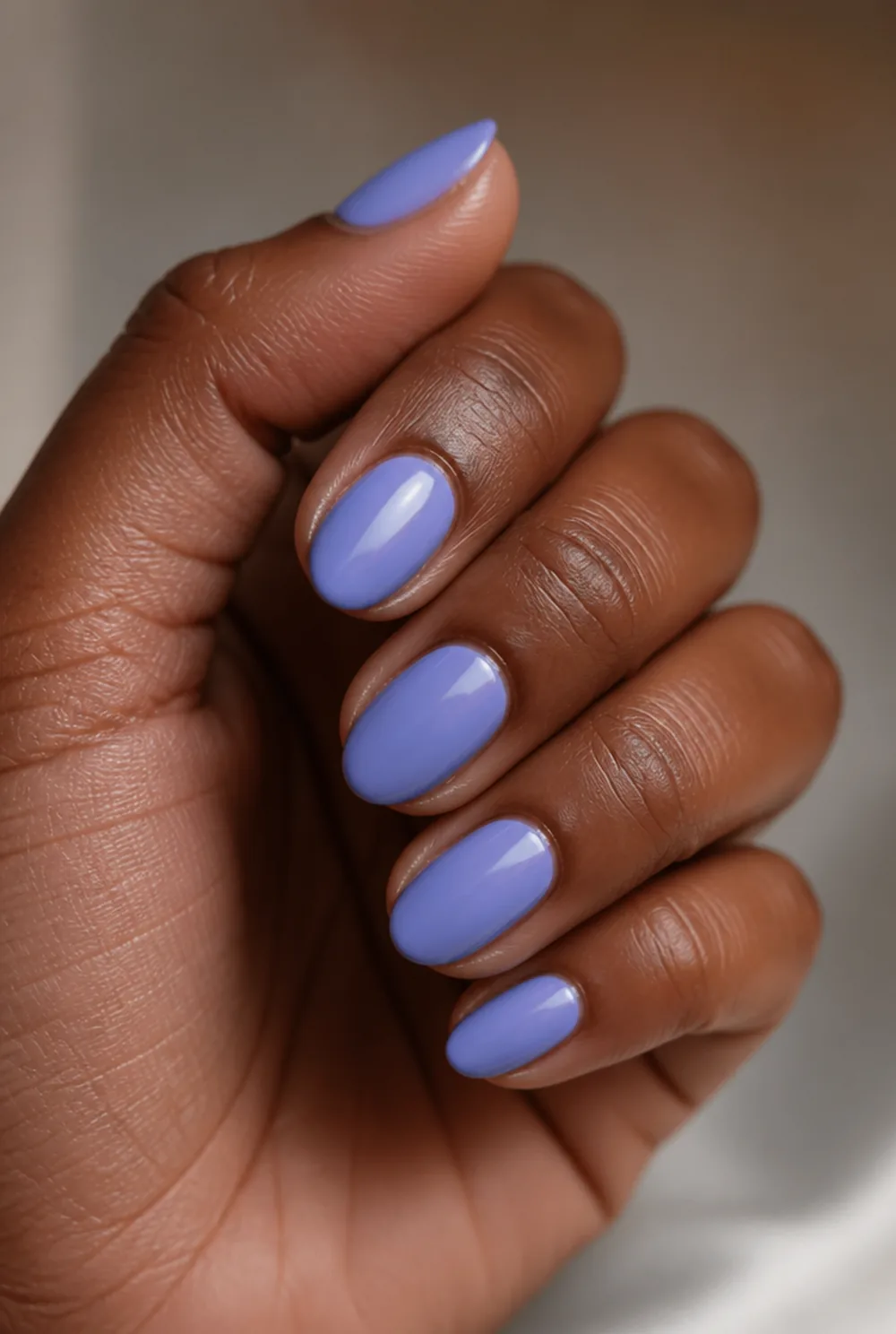 periwinkle nail art on deep brown skin