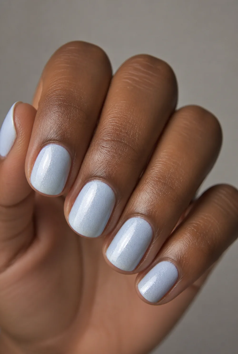 ice blue shimmer nail art on deep brown skin